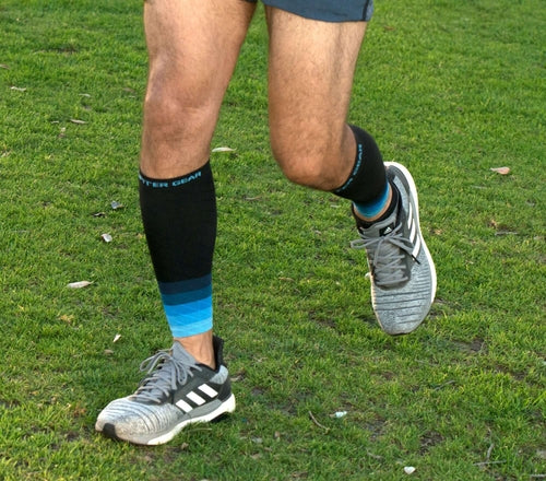 Victory Elite Endurance compression calf and leg sleeve for running and hiking shown on a leg in a natural outdoor setting.