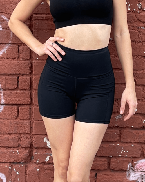 Victory Elite Jolie high-waisted athletic shorts with hip pockets, shown in black fabric with a comfortable fit.
